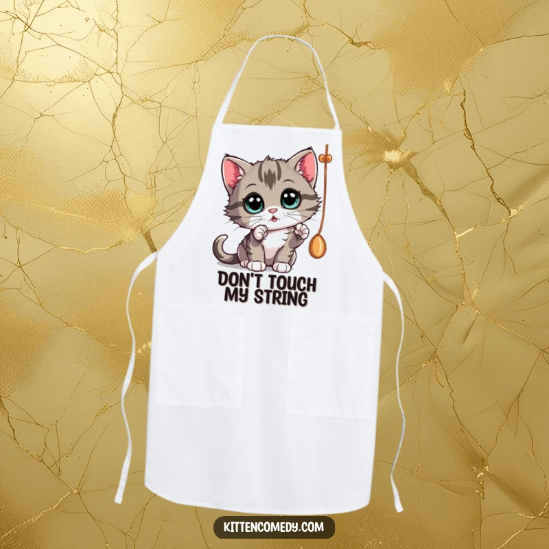 Funny curious kitten batting at a dangling string, a funny apron for kitchen fun and gifts.