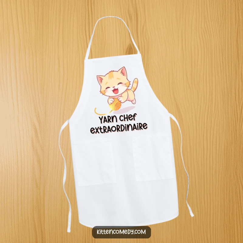 Funny kitten apron showing a joyful kitten tumbling hilariously while chasing a glowing yarn ball, perfect for kitchen fun.