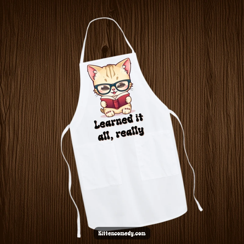 Funny apron depicting a giggling kitten wearing large glasses, absorbed in reading a tiny book, bringing intellectual humor to cooking.