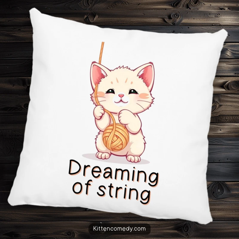 Funny kawaii kitten pillow depicting a plush toy batting playfully at a dangling yarn ball.