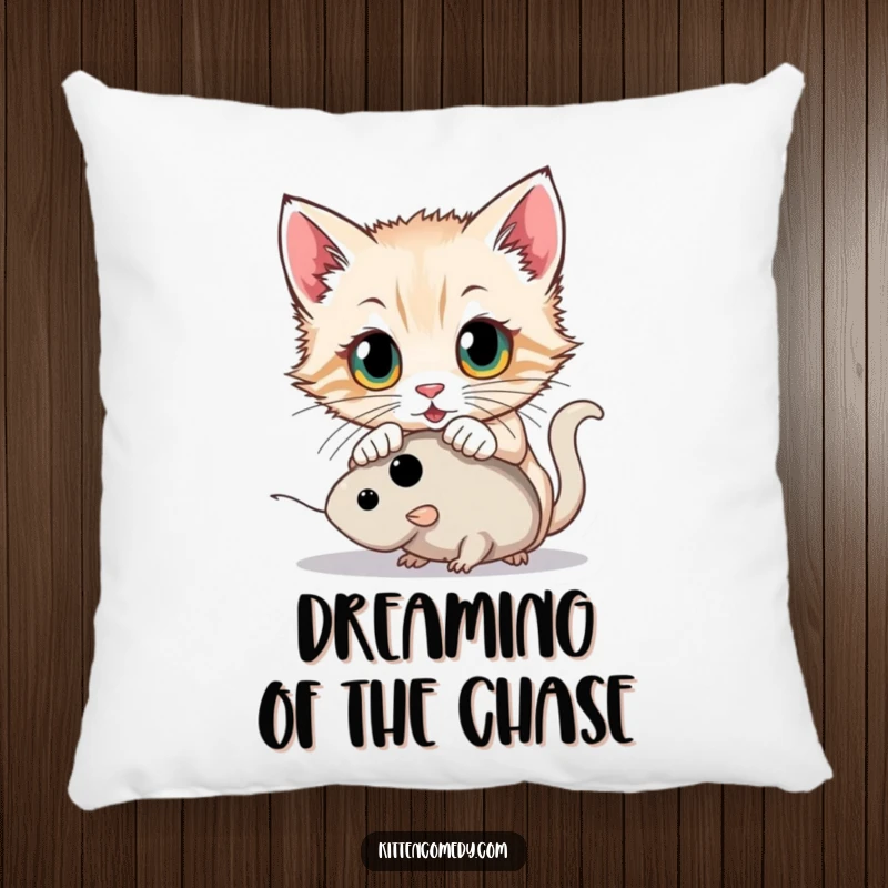 Funny kitten with wide eyes pouncing on a toy mouse on a soft pillow, creating a cozy and playful accent.