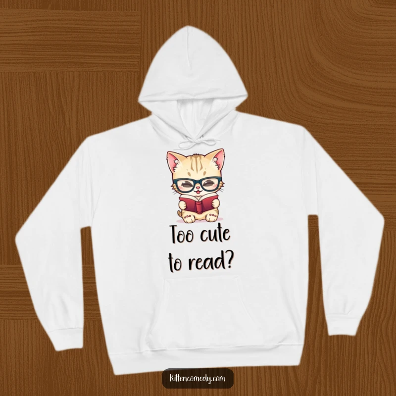 Funny hoodie with a giggling kitten character wearing large glasses, deeply focused on reading a tiny book, exuding smart humor.