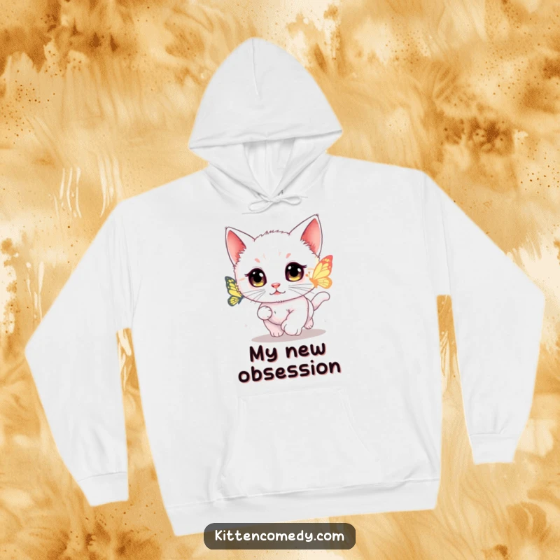 Funny kawaii kitten hoodie depicting a wide-eyed cat chasing a glowing butterfly with intense focus.