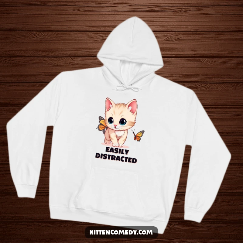 Funny cozy hoodie with a kitten that has wide, curious eyes chasing a butterfly, perfect for cat lovers seeking warmth.