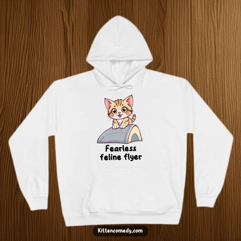 Funny sliding kitten hoodie, a kitten with wide eyes sliding down a ramp, offering warmth and a humorous depiction of adventure.