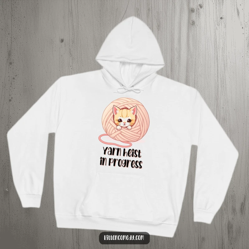 Funny kitten hoodie featuring a mischievous kitten peeking from behind a large ball of yarn, exuding playful secrecy and humor.