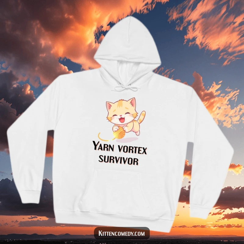 Funny kitten hoodie featuring a joyful kitten hilariously tumbling while pursuing a glowing ball of yarn, full of motion and humor.