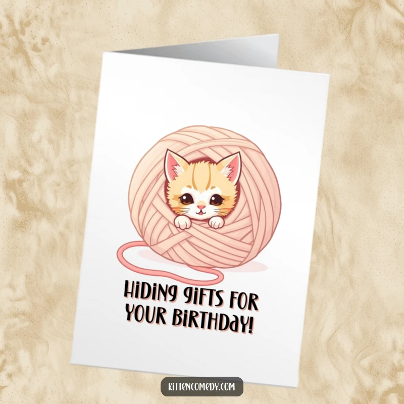 Funny Free Printable Birthday Card: A mischievous kitten peeks from behind a giant yarn ball, ready to play.