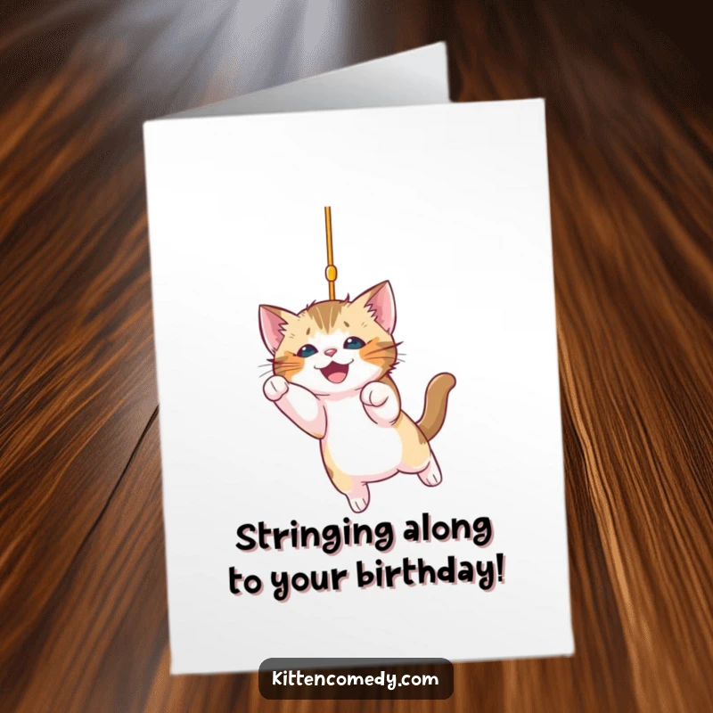 Funny Free Printable Birthday Card: Playful kitten excitedly pounces on a sparkling string, ready for birthday fun.