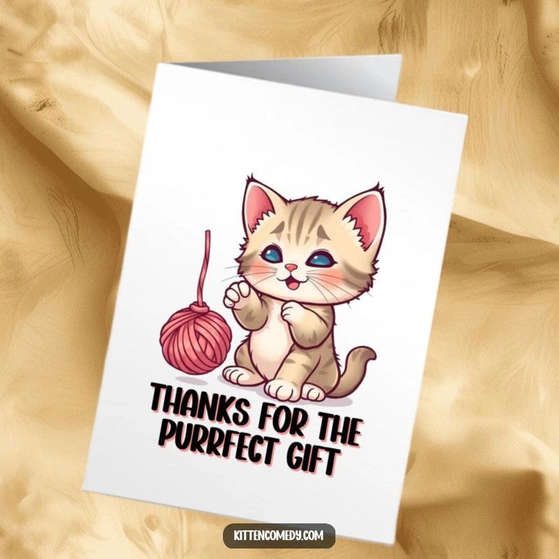 Funny Free Printable Thank You Card: A playful kitten batting at a ball of yarn, expressing thanks with humor, downloadable.