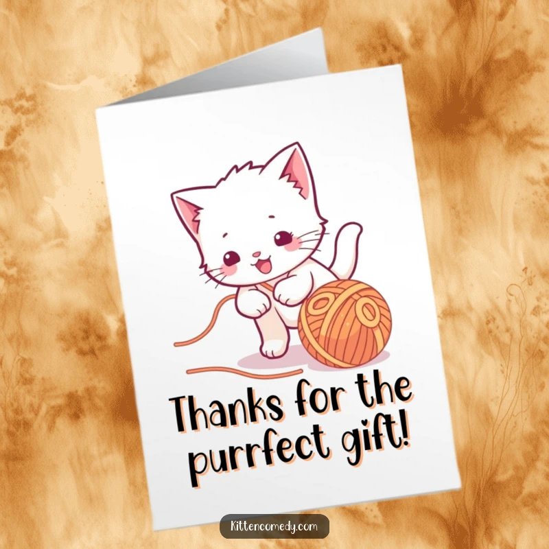 Funny Free Printable Thank You Card: Kawaii kitten character playfully batting at a rolling ball of yarn, offering thanks with delightful mischief.
