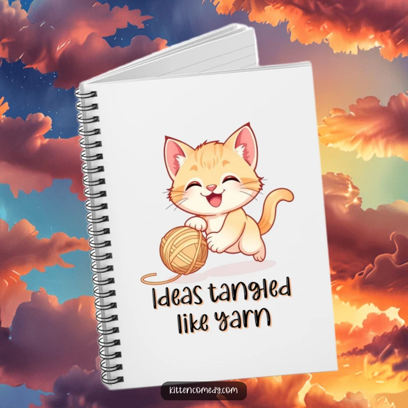 Funny happy kitten chasing a bouncing yarn ball, a notebook for journaling playful thoughts.