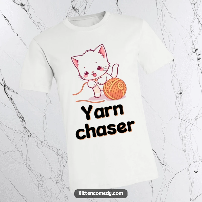Funny kawaii kitten t-shirt, enthusiastically chasing a rolling ball of yarn, a playful and adorable scene.