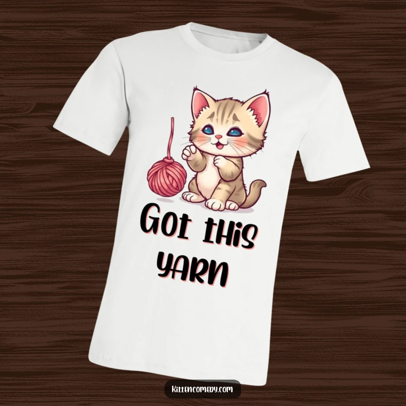 Funny Kitten Yarn T-Shirt: A playful kitten engrossed in batting a dangling yarn ball, a fun and funny gift idea.