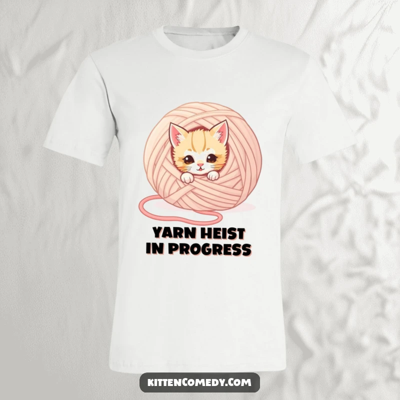 Funny kitten t-shirt with a mischievous kitten peeking playfully from behind a huge ball of yarn, capturing a humorous hidden moment.