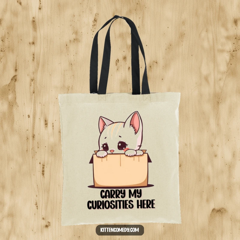 Funny kitten character with wide eyes peeking into a box, featured on a durable tote bag, perfect for a funny and practical cat-themed gift.
