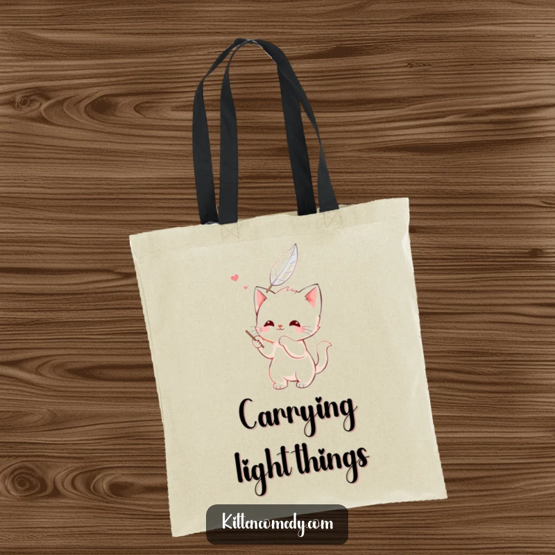 Funny kawaii kitten tote bag, happily batting at a feather, a cute and playful character.