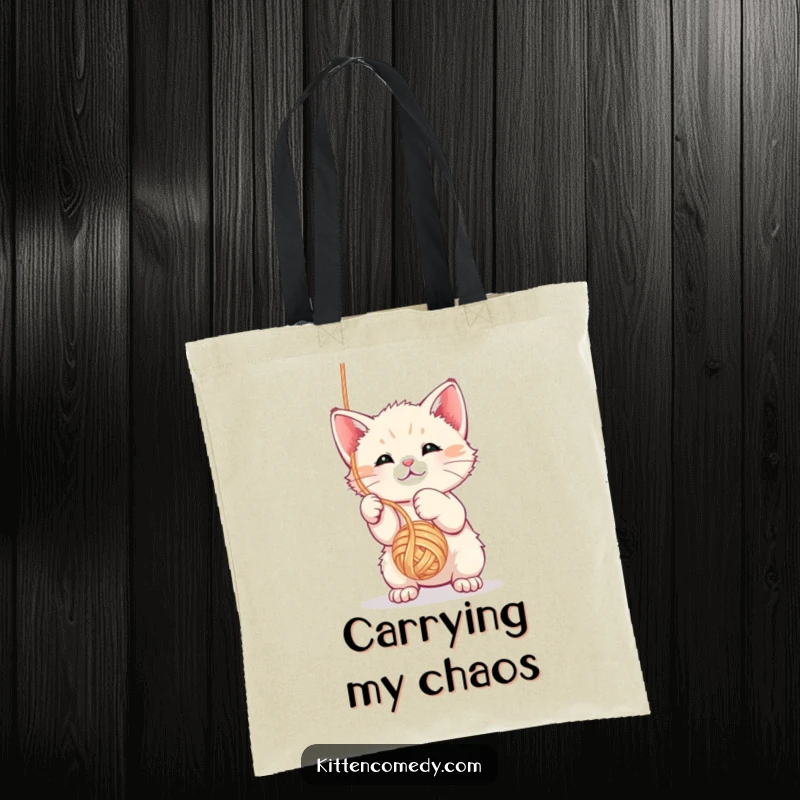 Funny kawaii kitten tote bag depicted mid-play, swatting at a dangling yarn ball with glee.