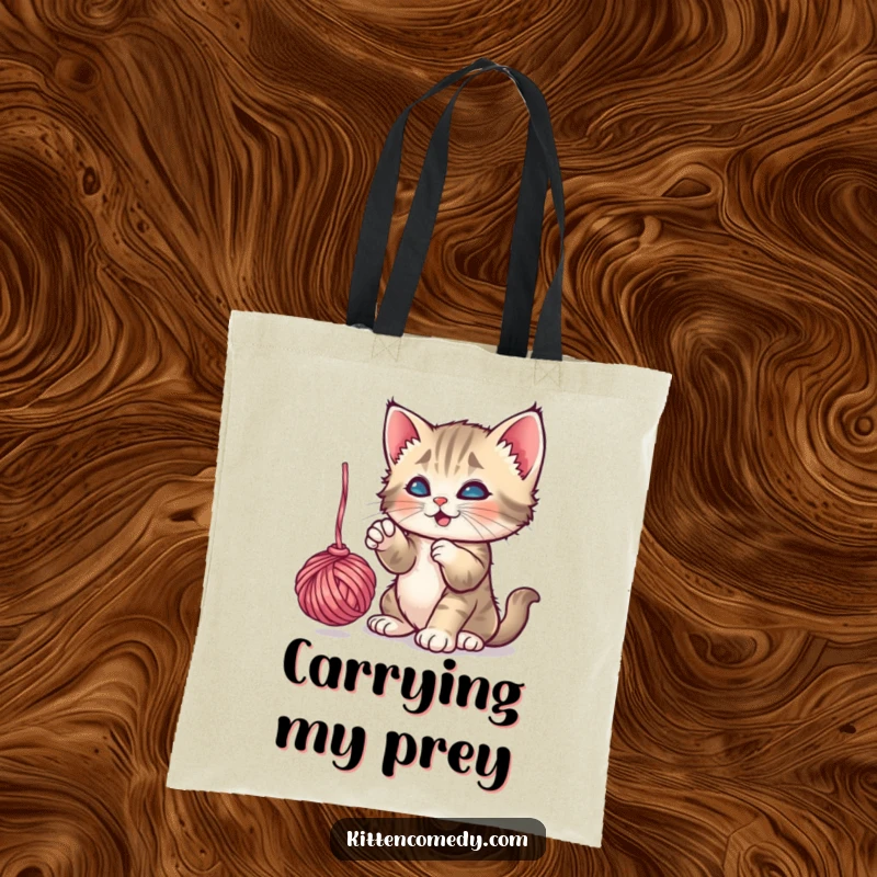Funny Kitten Yarn Tote Bag: A playful kitten batting at a dangling yarn ball, making it a fun funny gift.