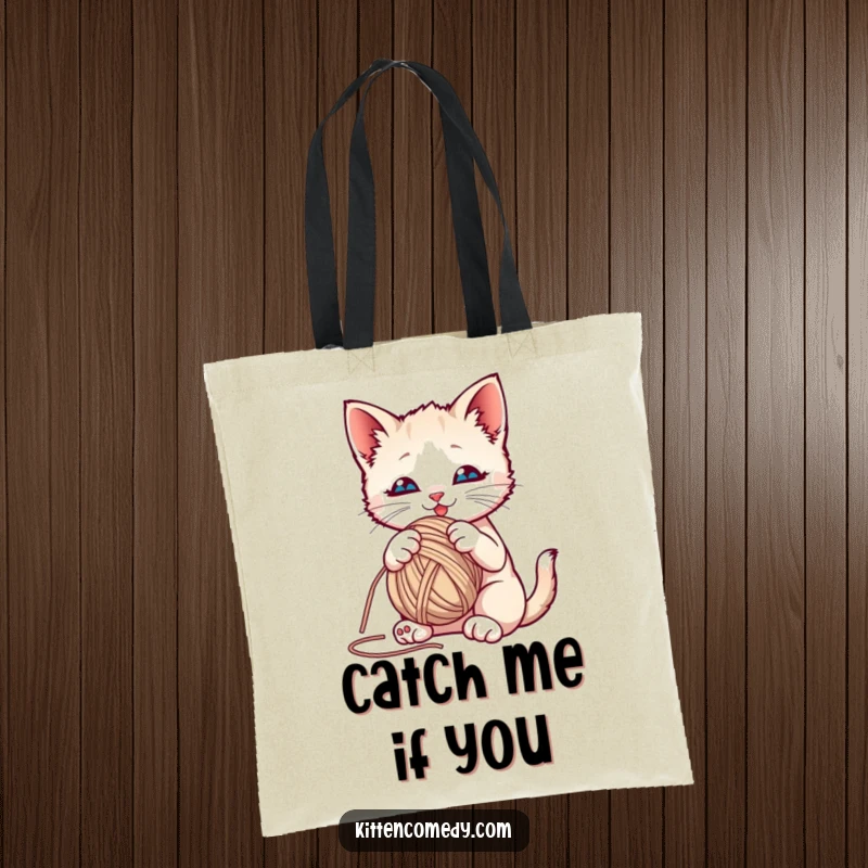 Funny kitten playfully batting at a colorful yarn ball on a reusable tote bag, perfect for carrying daily joys.