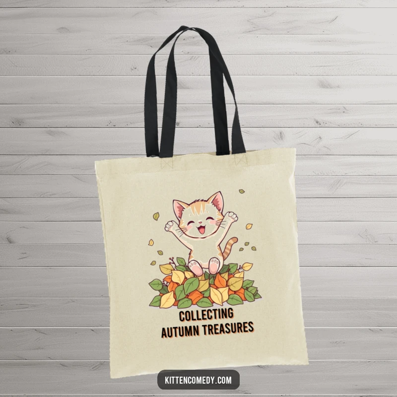 Funny kitten tote bag depicting a cat making a joyful leap into a pile of autumn leaves, a whimsical accessory for fall lovers.