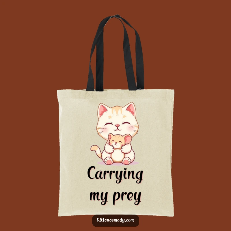 Carry your essentials with a smile in this funny tote bag featuring a kitten offering a toy mouse. Practical, cute, and full of playful charm.
